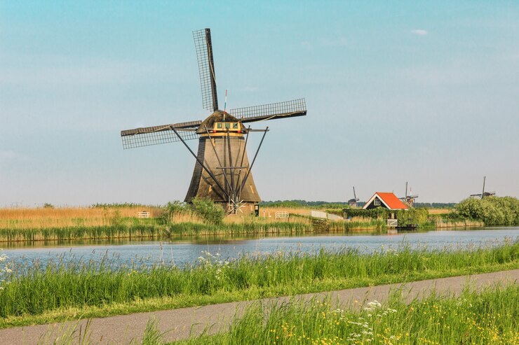 traditional-dutch-windmills-with-green-grass-foreground-netherlands_155003-16681